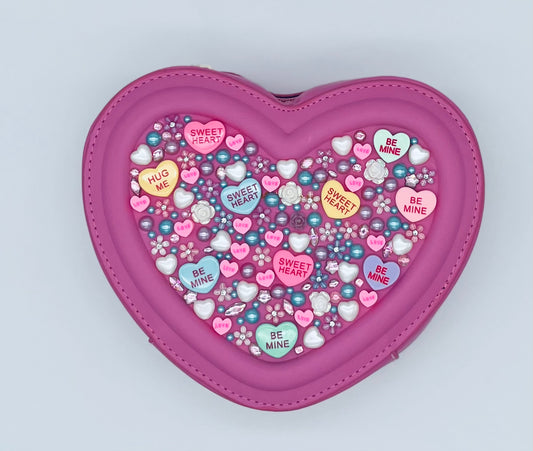 fuchsia pink valentines day love purse shaped like a heart with bling and candy message hearts adorned all over